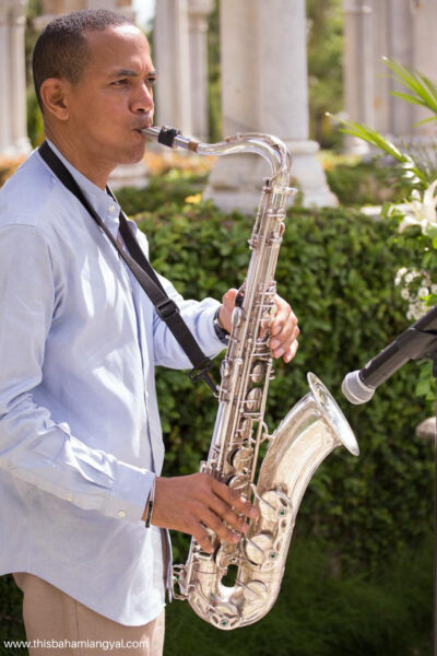 A saxophone player plays Luther Vandross' So Amazing at This Bahamian Gyal blogger, Rogan Smith's eighth wedding anniversary at their vow renewal ceremony in The Bahamas.