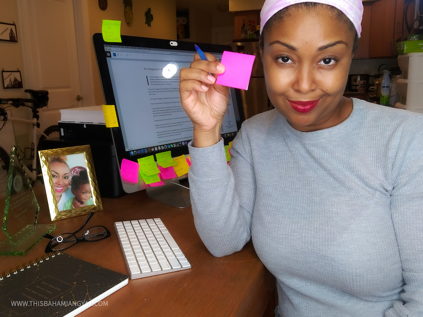 This Bahamian Gyal Creative Director and blogger, Rogan Smith holds up a sticky note. She goes through a ton of these in any given week and is always making notes of things to do for her blog. 