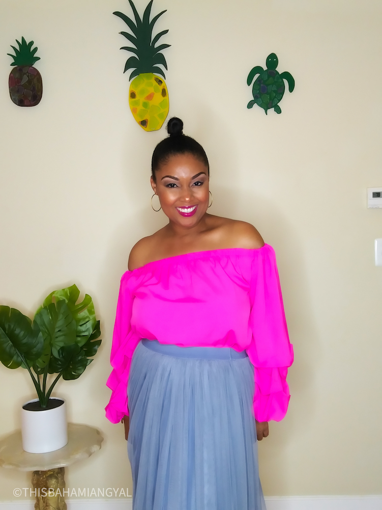 DC-based blogger, Rogan Smith wears a pink  off-the-shoulder blouse with a grey/blue tulle skirt.