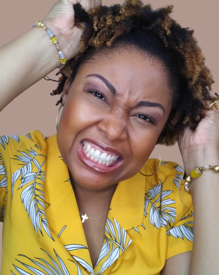 black woman shows her natural 4c hair twistout