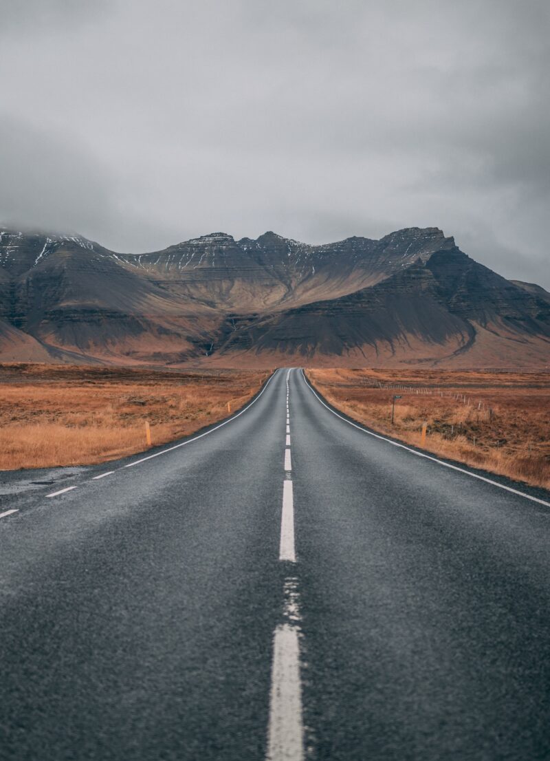 Photo of an empty road with mountains in the back. Photo by pexels-sebastian-palomino-1955134