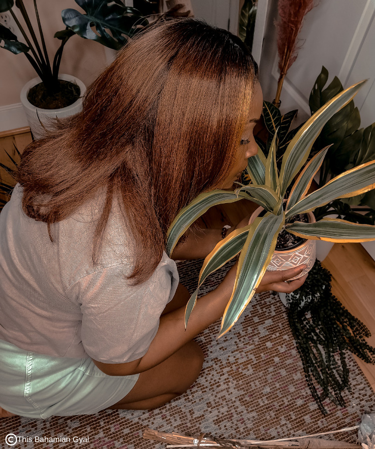 Washington DC blogger Rogan Smith sits on the floor and smells her plants