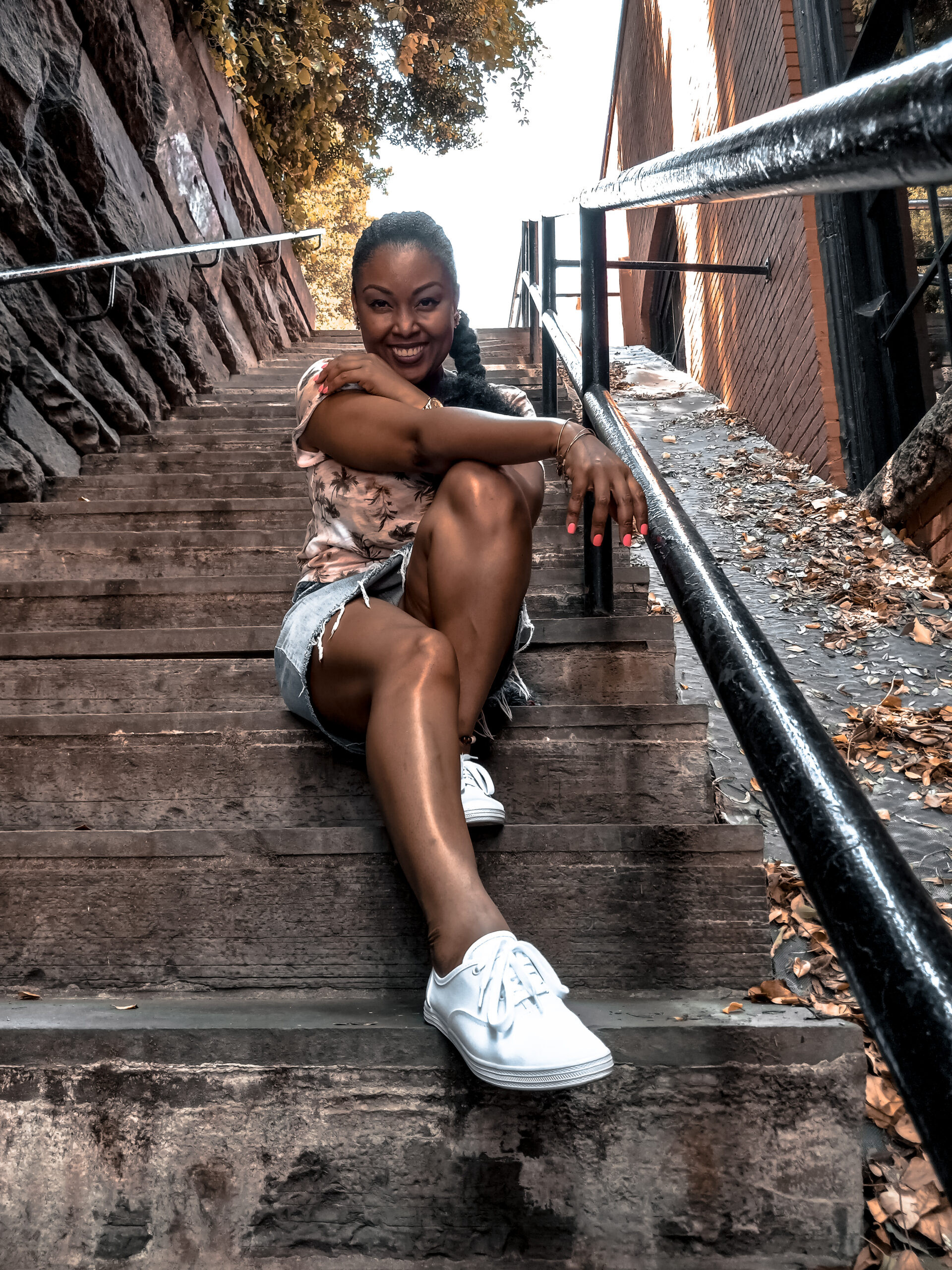 DC blogger Rogan Smith of This Bahamian Gyal poses on The Exorcist Steps in Georgetown DC
