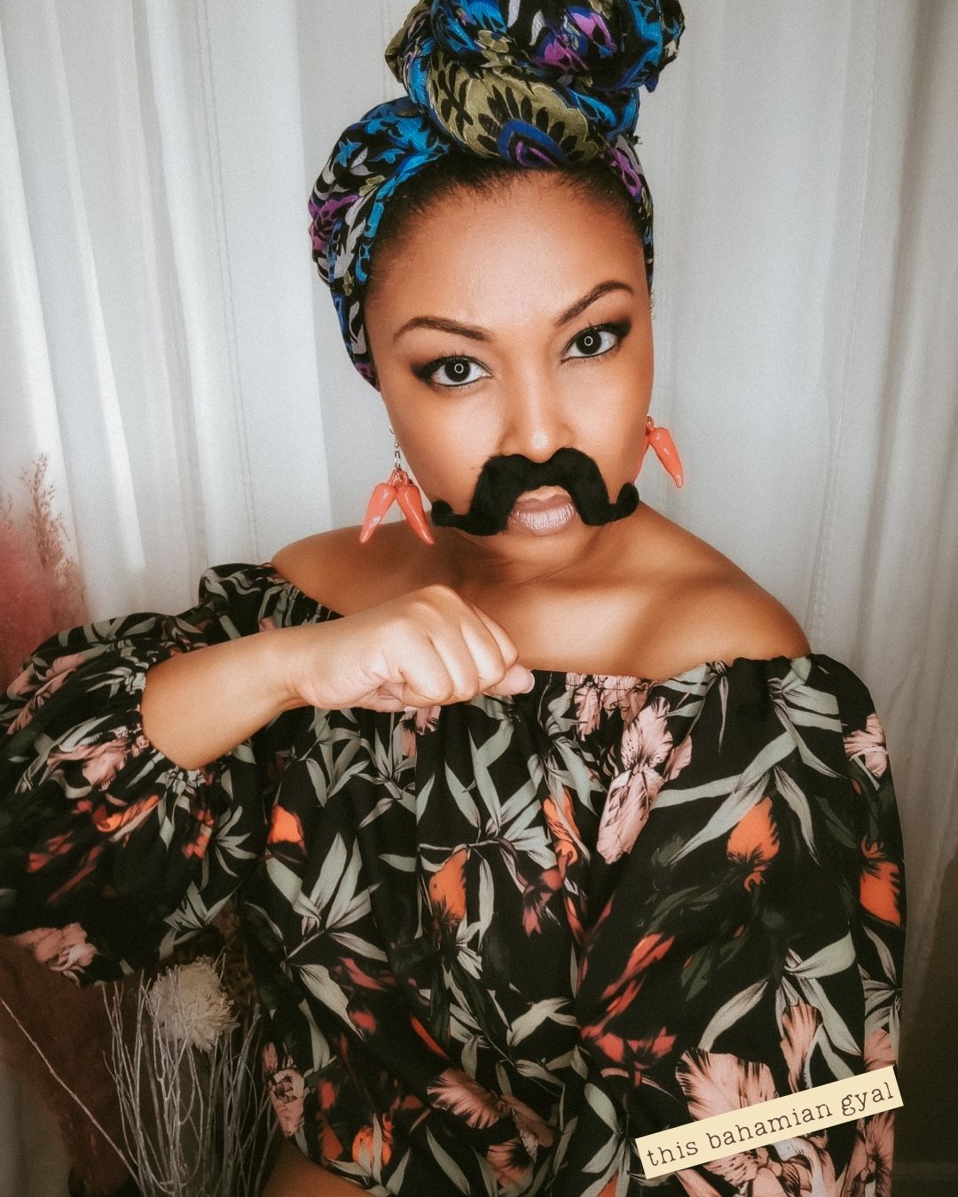 DC blogger This Bahamian Gyal wears a mustache and pepper earrings to celebrate Cinco de mayo.