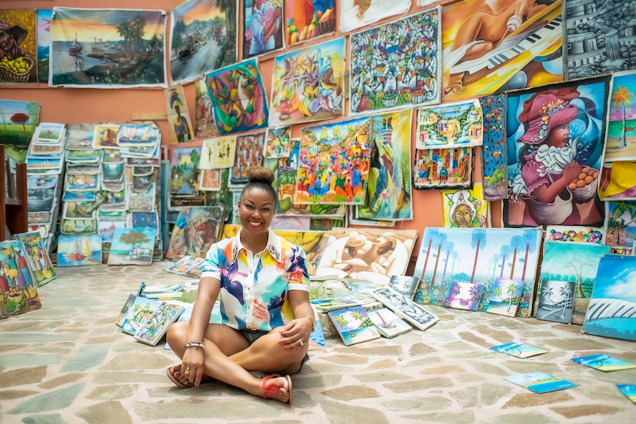Blogger Rogan sits among artwork in Nassau, Bahamas