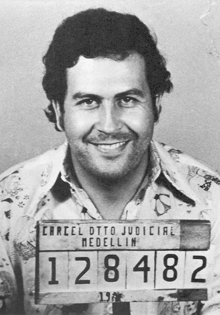 Mugshot of notorious drug kingpin, Pablo Escobar. Escbobar smiles in his mugshot.