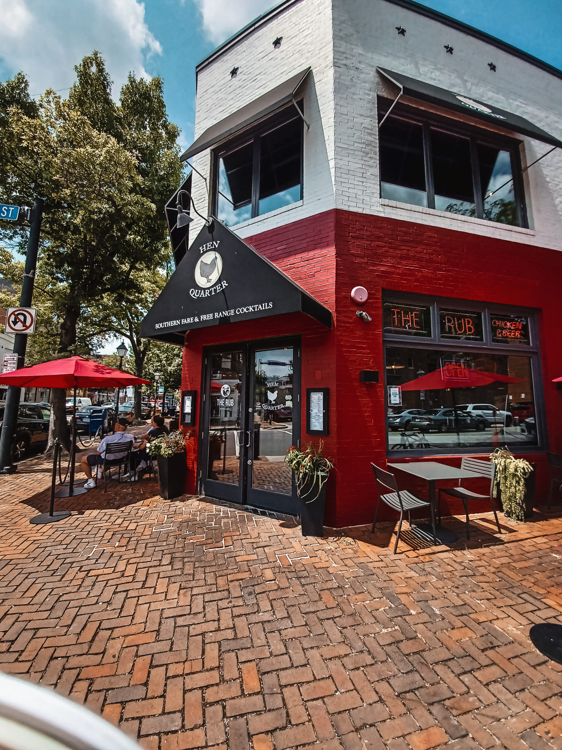 Photo of Hen Quarter restaurant in Alexandria Virginia. The building is red and white and black.