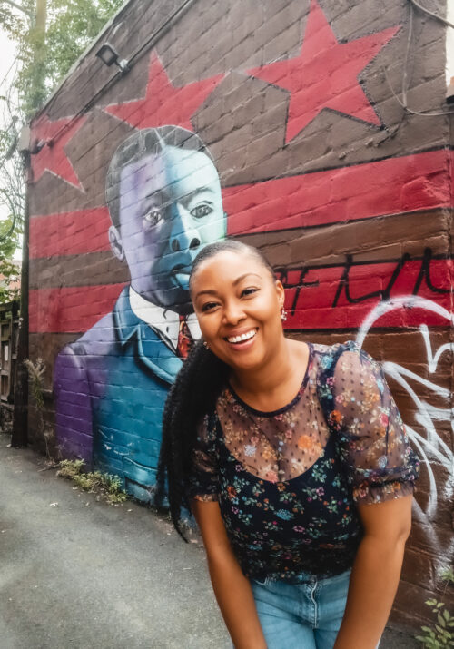 This Bahamian Gyal blogger Rogan Smith poses in front of the Paul Laurence Dunbar mural in Washington DC