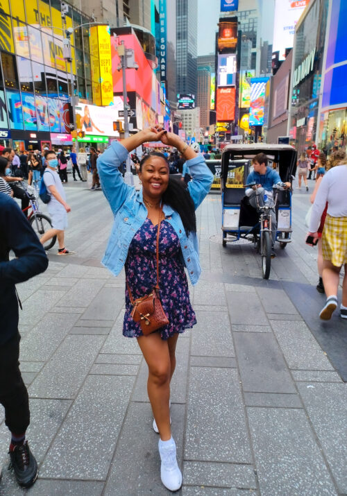 This Bahamian Gyal blogger Rogan Smith smiles in Times Square New York City