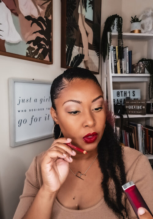 Washington DC blogger Rogan Smith holds a red lipstick and liner in her hands