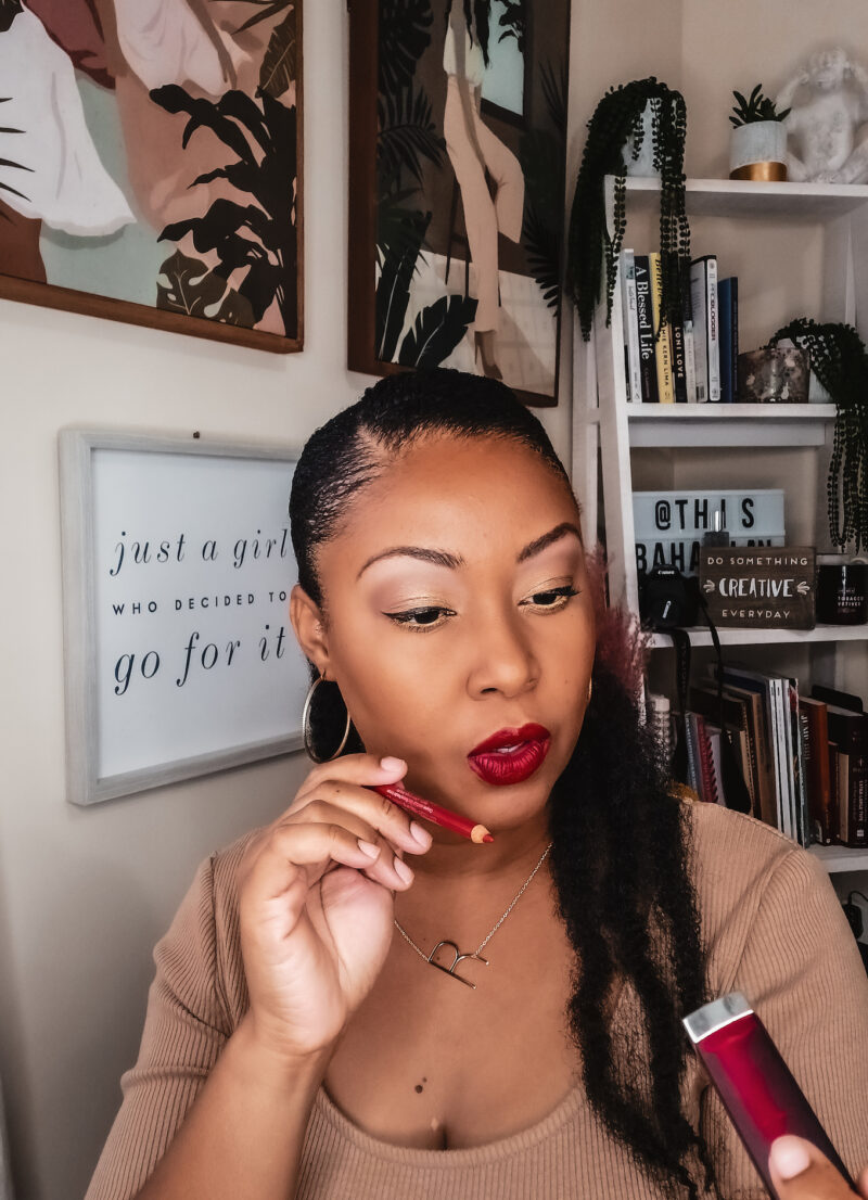 Washington DC blogger Rogan Smith holds a red lipstick and liner in her hands