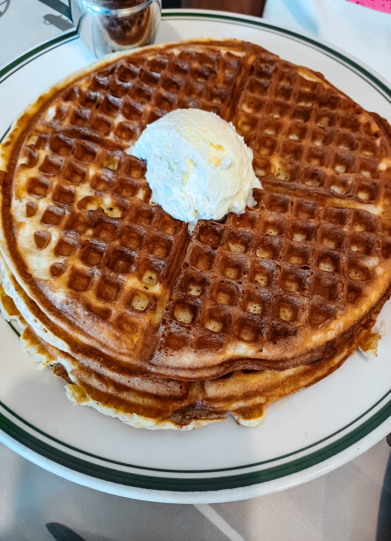 a plate of waffles with butter on top from ari's diner in washington dc