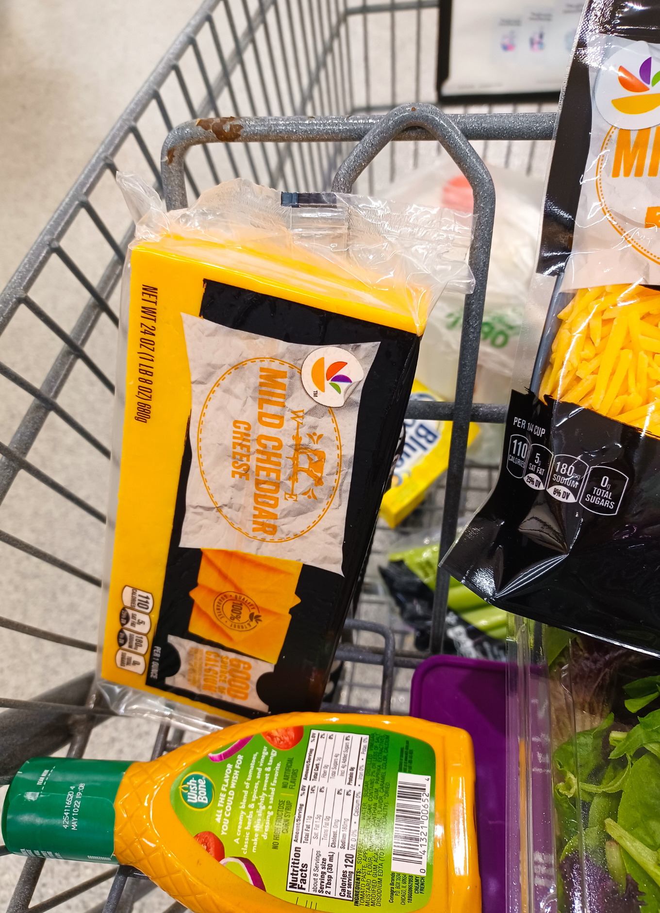 A grocery cart of mild cheddar cheese
