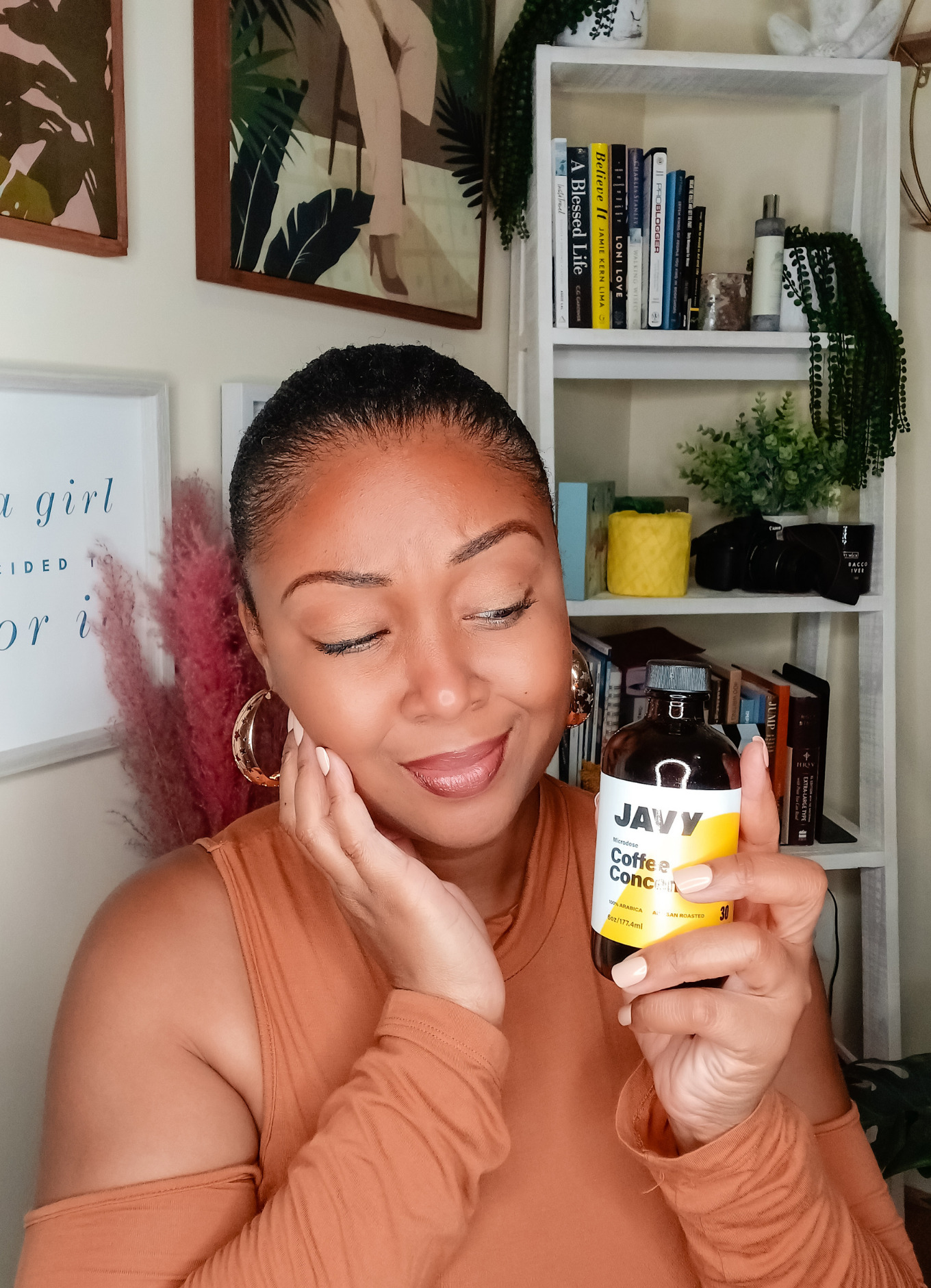 Black blogger holds Javy concentrated cofeee in her hand and holds her face