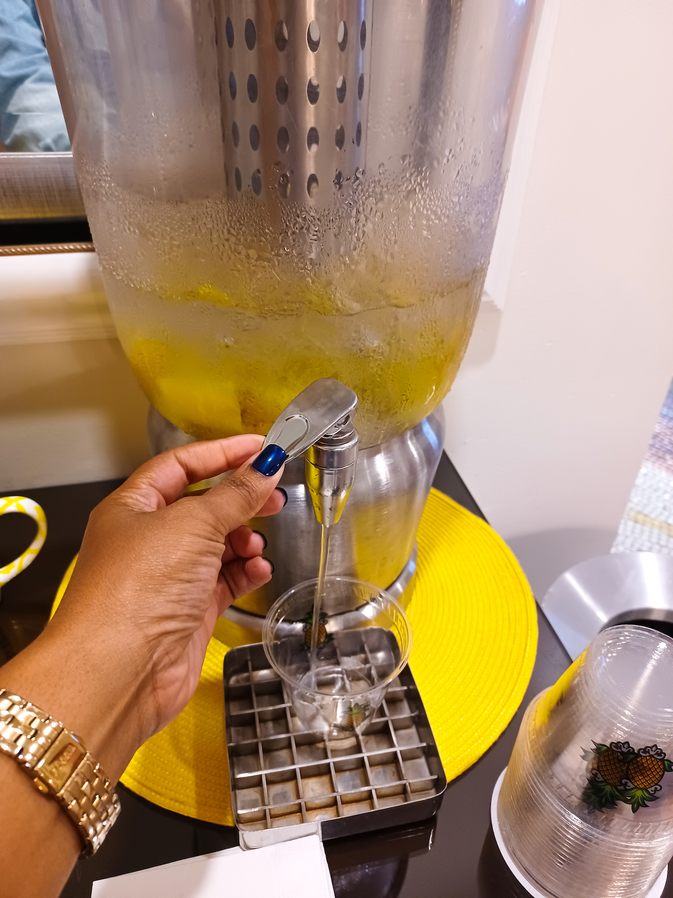 This Bahamian Gyal blogger Rogan Smith pours pineapple infused water at StayPineapple Hotel in New York City
