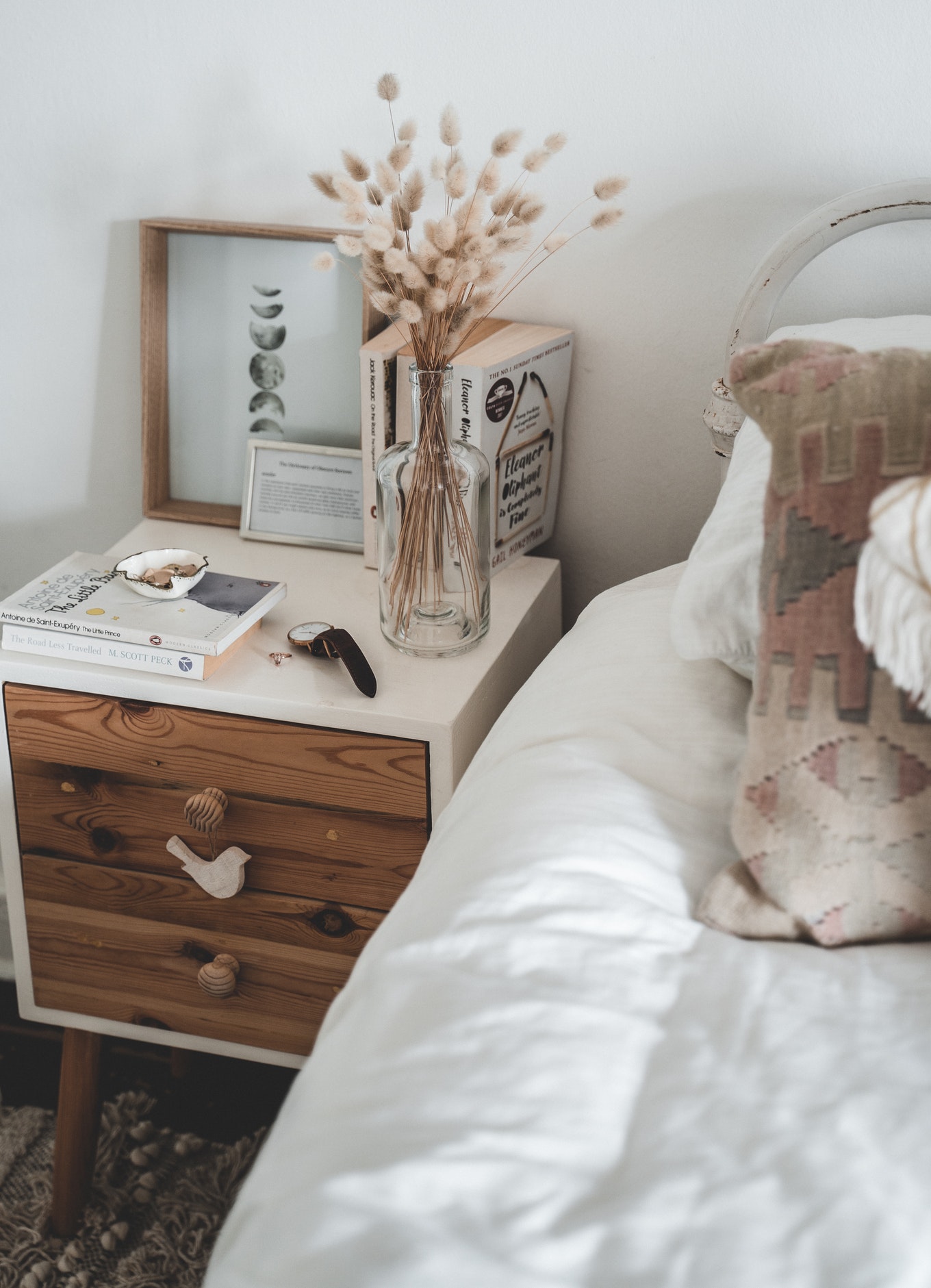 interior bedroom muted colors bed and wooden nightstand