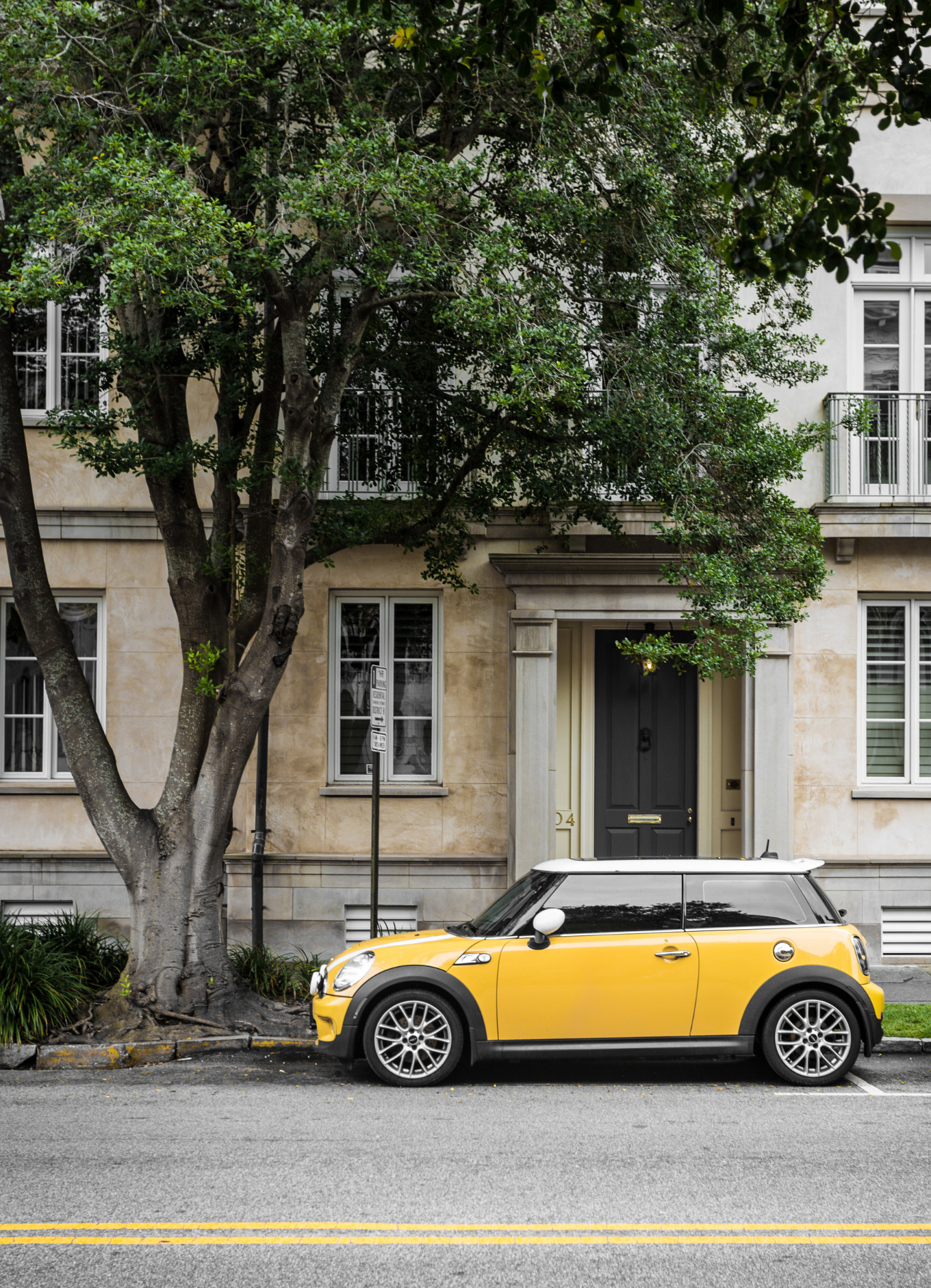 Photo of a yellow Mini Cooper car parked on street