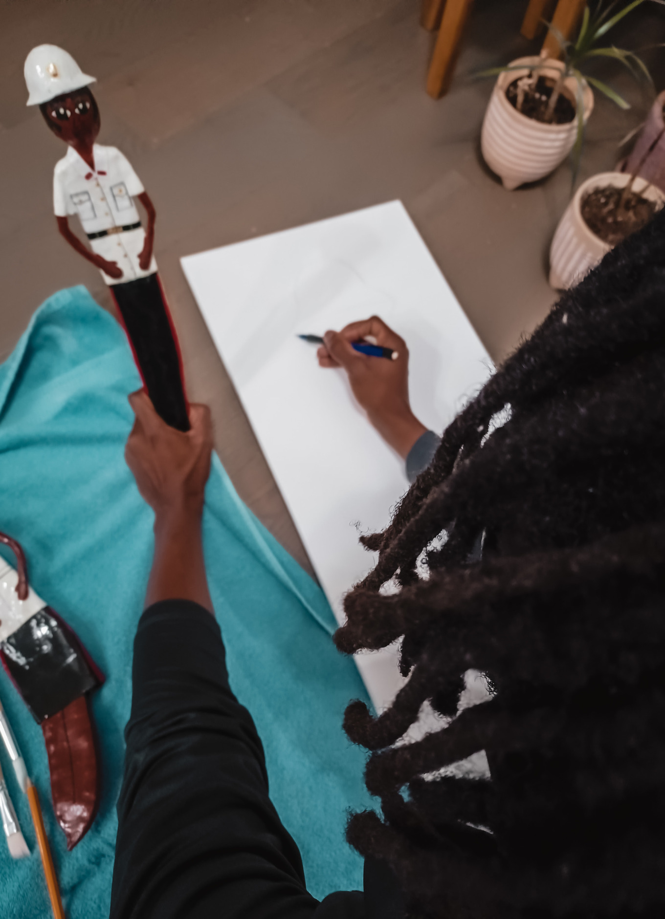 Oh Brother! My brother, Rashad helps recreate some Bahamian police officer dolls on canvas.