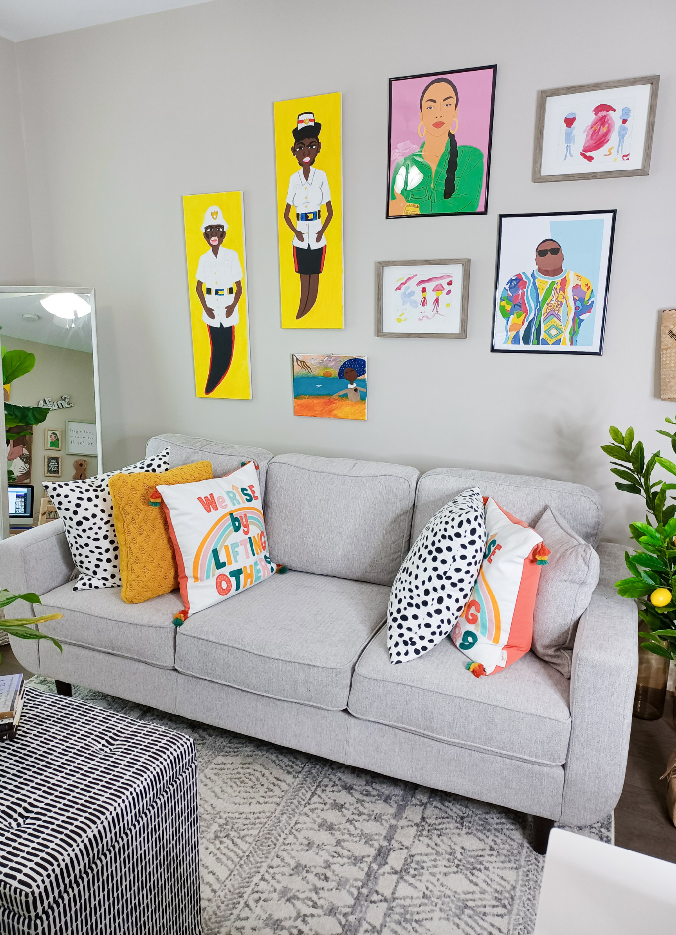 A HomeGoods gray sofa sits in this colourful studio apartment
