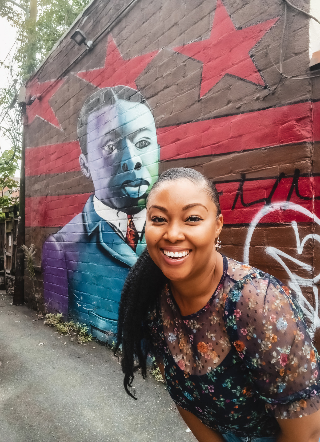 This Bahamian Gyal blogger, Rogan Smith poses in front of a mural in Washington, DC