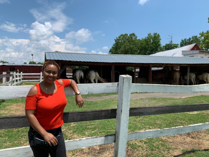 This Bahamian Gyal blogger, Rogan poses in front of a horse stable at Piscataway Riding Stable. She is about to ride one of the horses in the back.