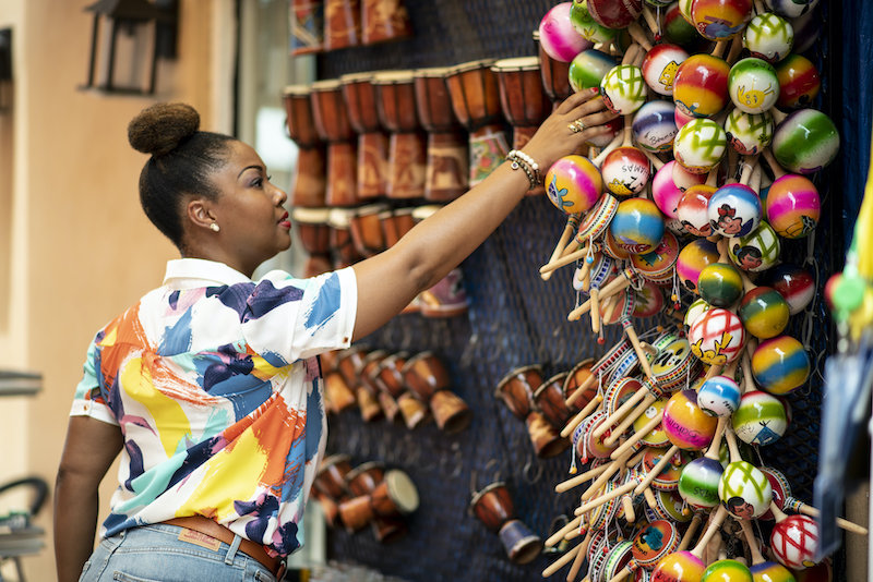Bahamian Blogger, Rogan Smith buys a souvenir in Downtown Nassau. The Bahamas is now open for travel.
