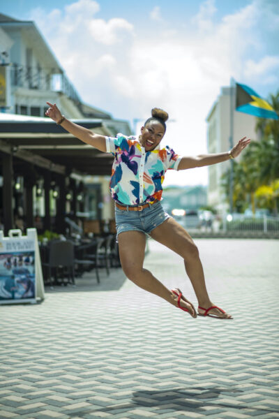 This Bahamian Gyal blogger, Rogan Smith jumps for joy because The Bahamas reopens for travel on Wednesday. Photo/T. Glinton Photography)