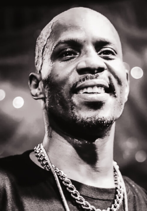 Black and white photo of rapper DMX, who smiles in the photo.