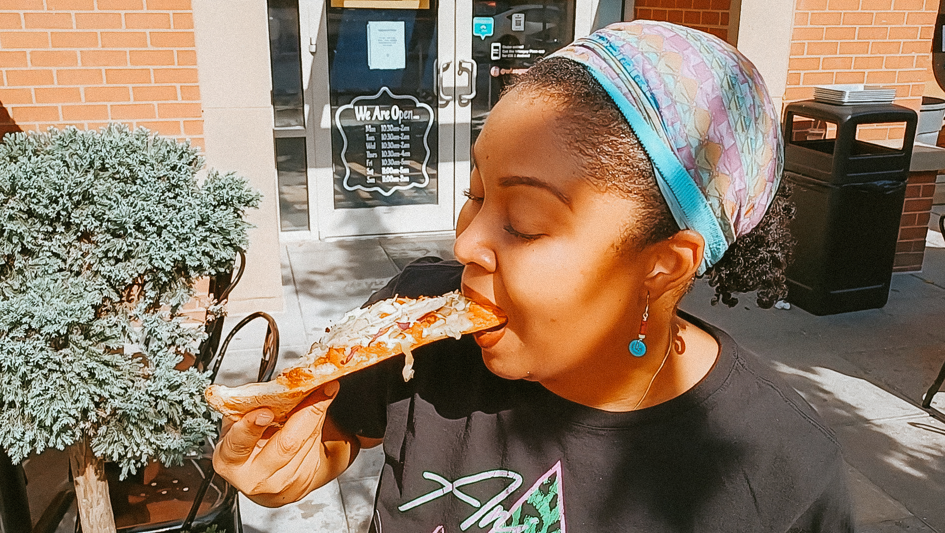 Black woman with natural hair eats Wiseguy Pizza - This Bahamian Gyal