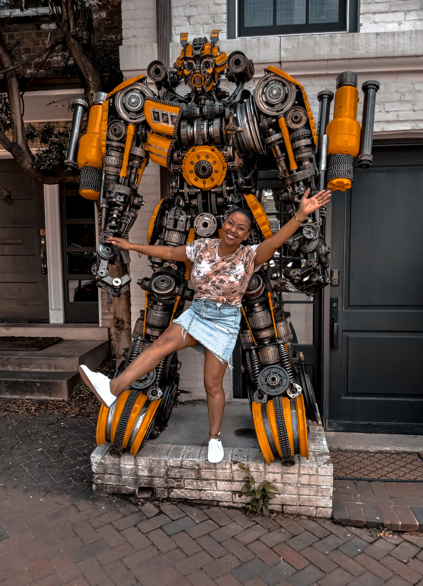Blogger Rogan Smith smiles and poses in front of the Bumblebee Transformer in Georgetown, DC