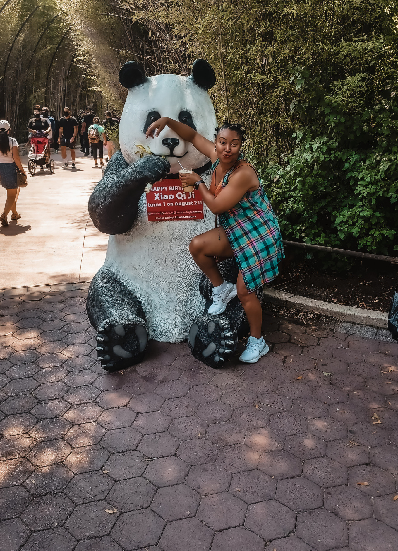 Blogger Rogan Smith poses with a panda statue in front of the DC Zoo