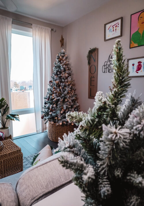 A neutral-coloured Bohemian Christmas tree sits in a warm Washington, DC apartment. The decor makes this small apartment feel more Christmasy.