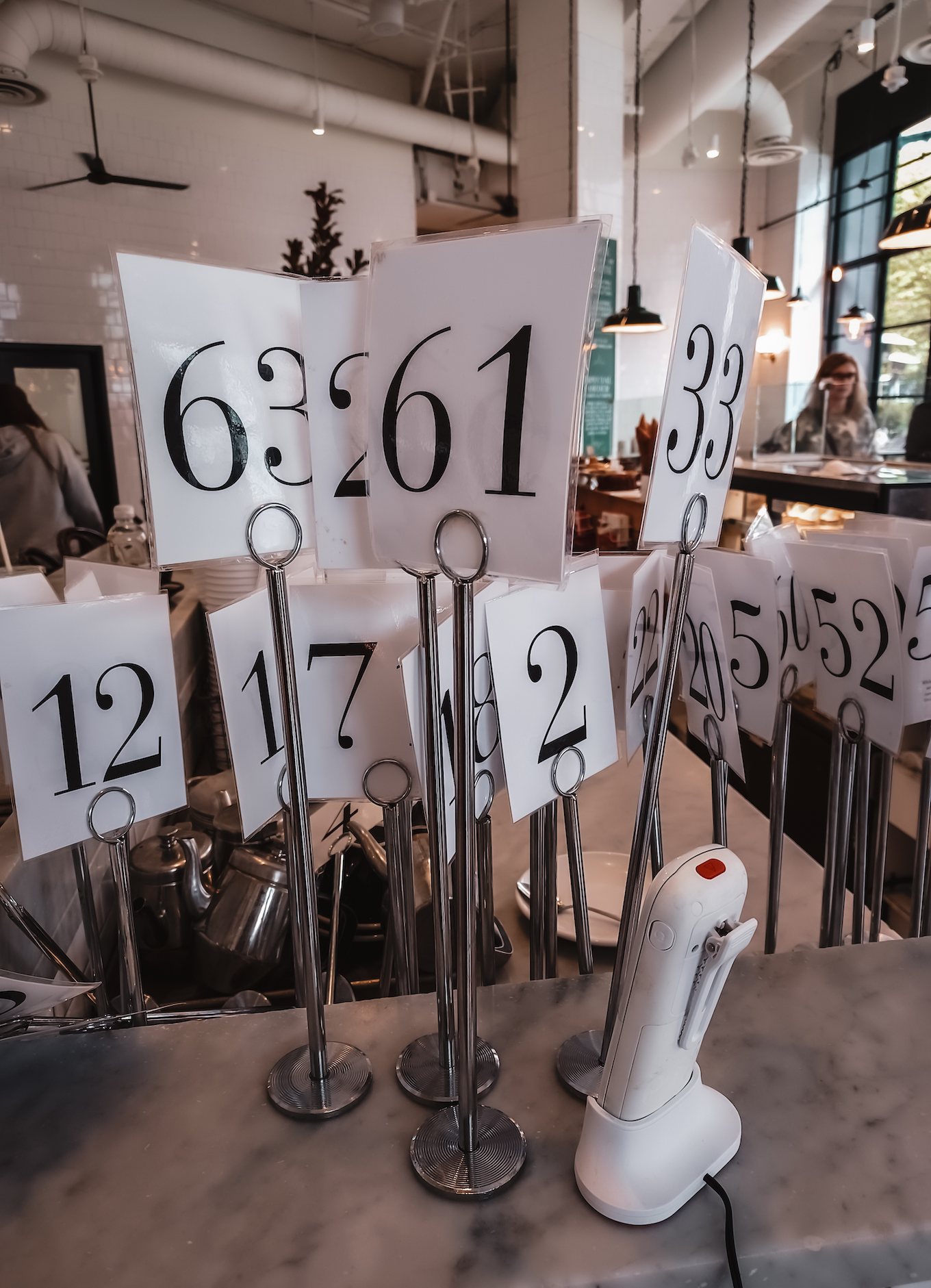 Several stands of numbers sit on the counter for customers to take.
