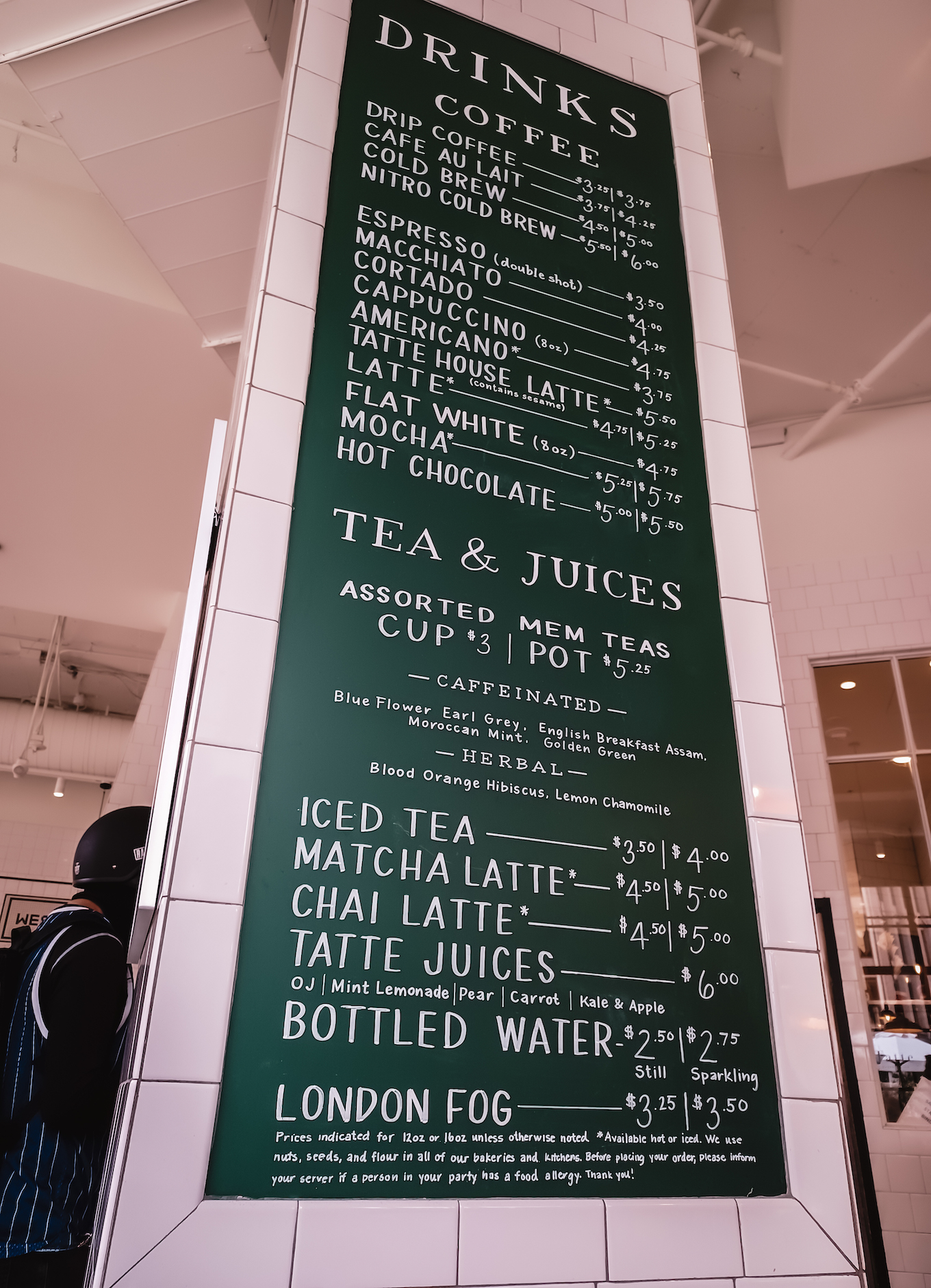 A green menu board inside Tatte Bakery.