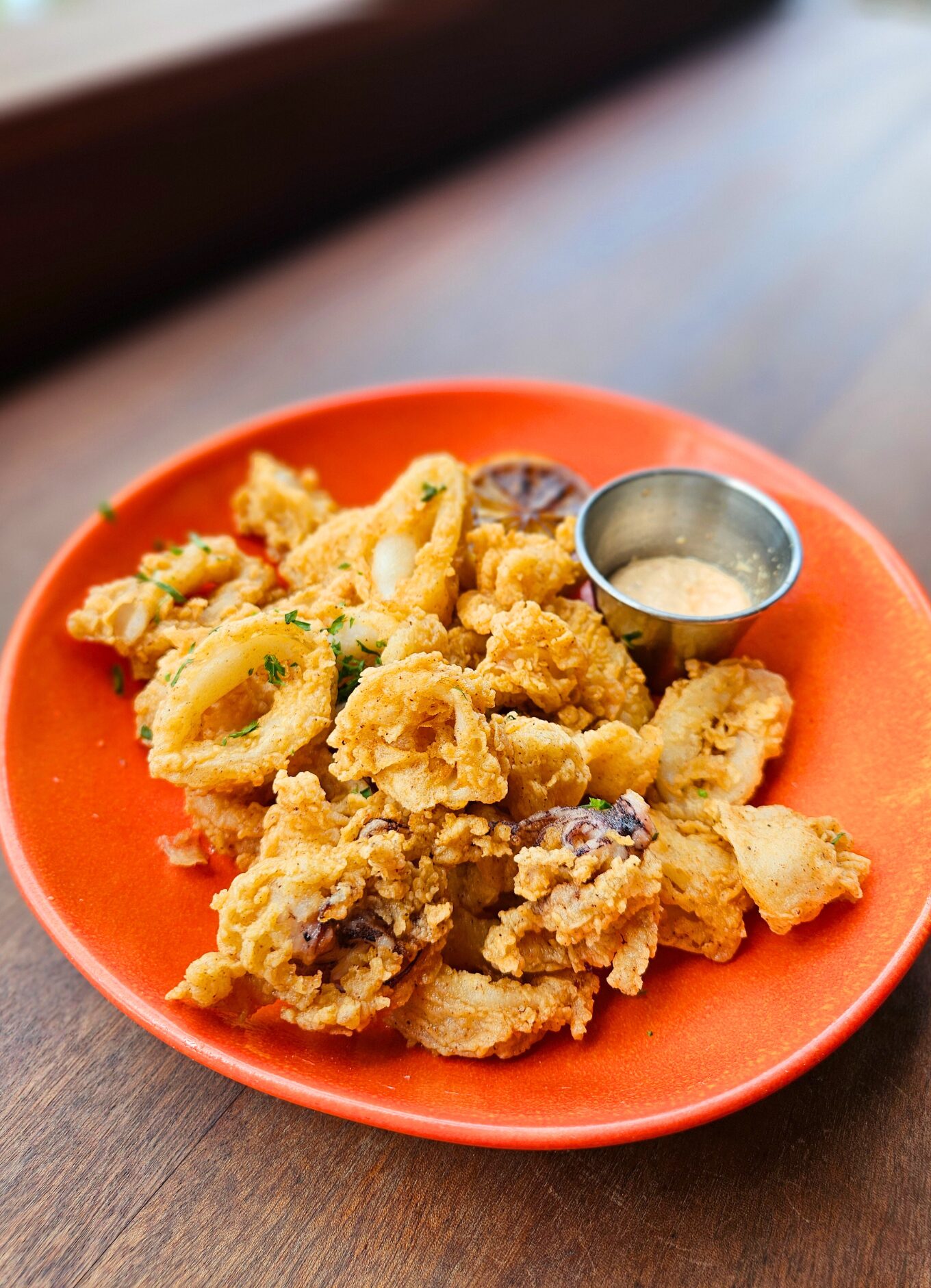 An orange bowl of calamari rings 