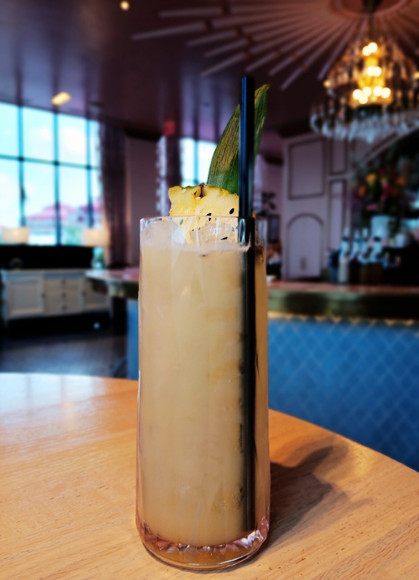 A light green mocktail called Secret Garden sits on a table.