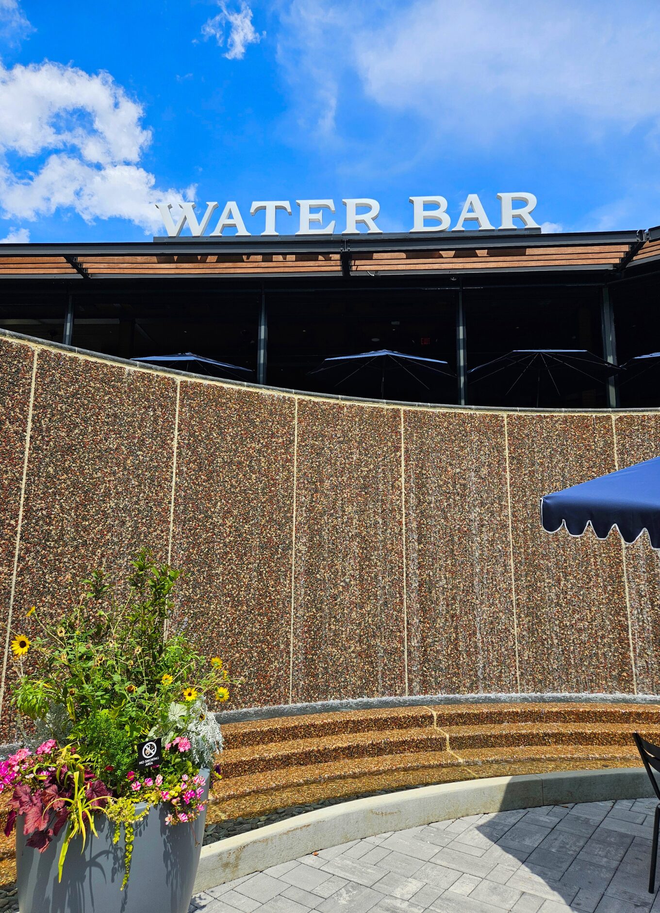 The water sculpture in front of Water Bar restaurant. It looks like a waterfall.