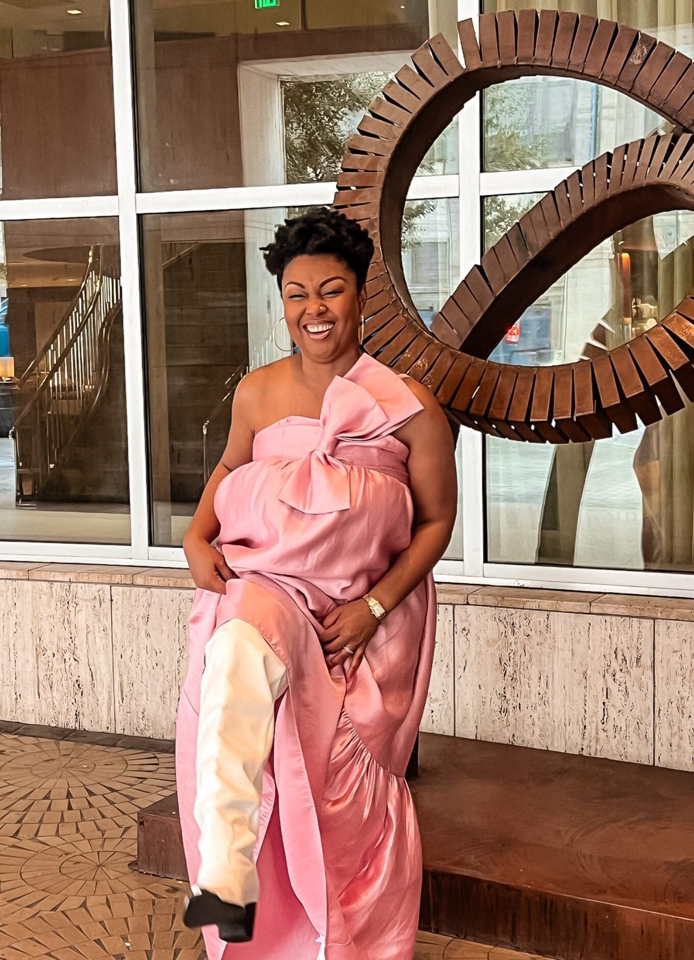 This Bahamian Gyal blogger, Rogan laughs as she shows off her white boots and pink dress