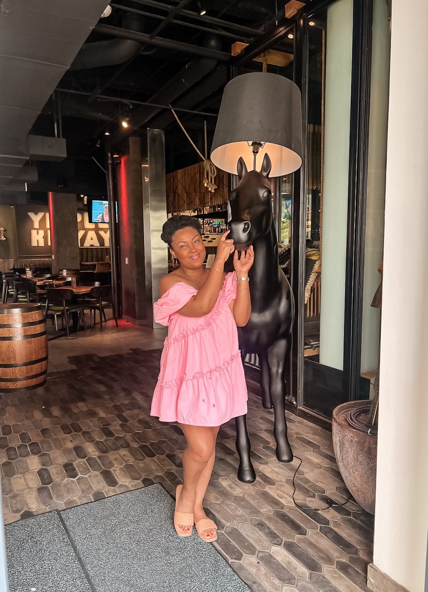 This Bahamian Gyal blogger, Rogan poses with a fake horse in Downtown Dallas, Texas