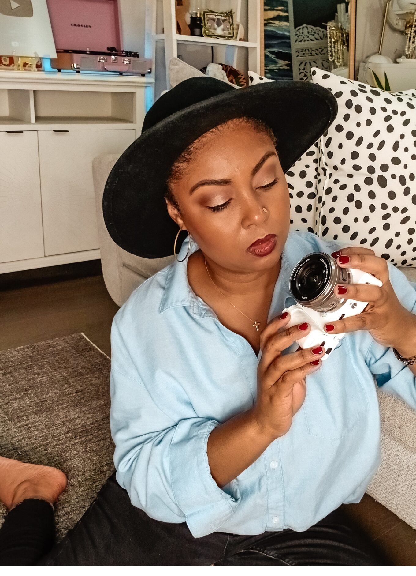 This Bahamian Gyal blogger Rogan sits on the floor of her DC apartment, inspecting her white Sony camera