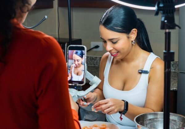 How to find your YouTube niche. Two women record food tutorials in the kitchen with ring lights
