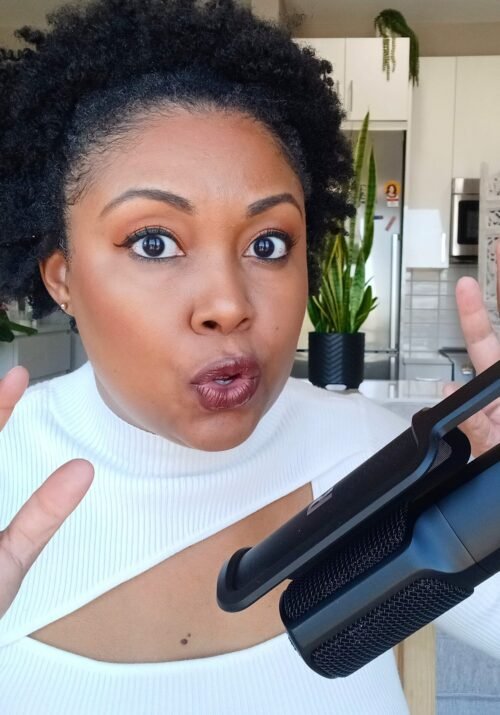 Illustration of This Bahamian Gyal blogger, Rogan speaking into microphone and showing how strong YouTube storytelling keeps viewers engaged and watching longer.